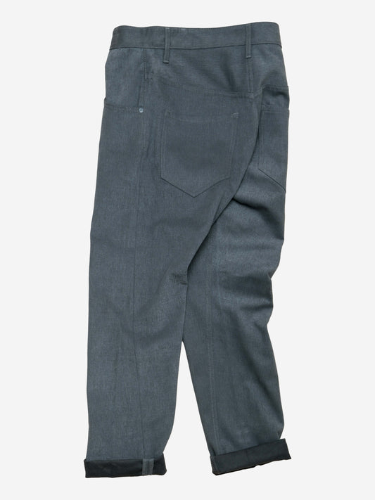 Rear view of relaxed fit pants in smoke brushed twill fabric, featuring a single back pocket, belt loops, and rolled cuffs for a casual military-inspired look.