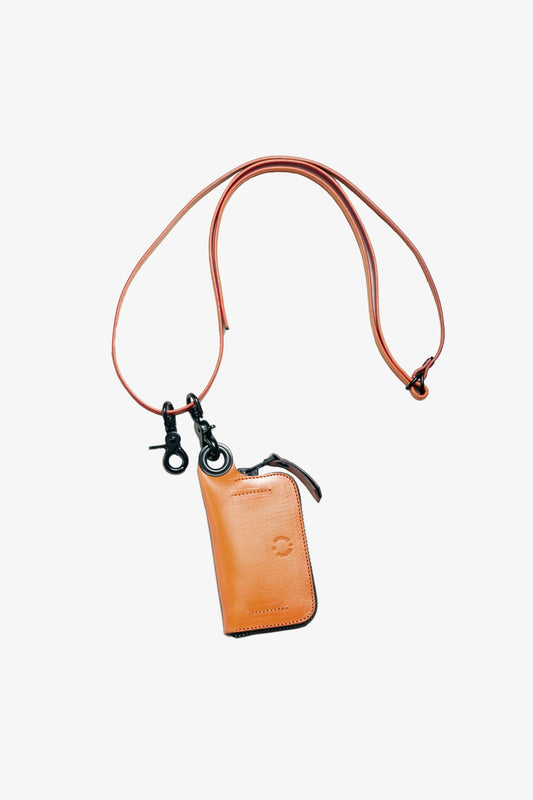 Orange leather strap with black metal clasps attached to a small leather pouch, featuring a minimalist design and smooth finish.