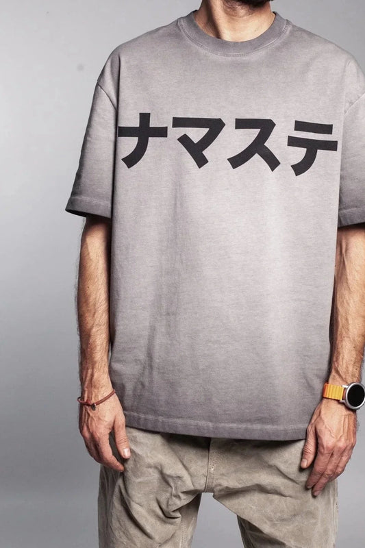 Model wearing a grey faded T-shirt with Japanese characters on it