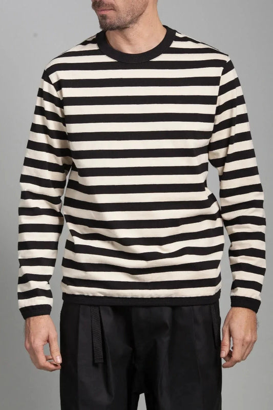 Model wearing black and off-white horizontal striped long-sleeve shirt