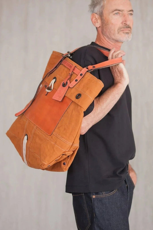 Side view of a man wearing a tote bag