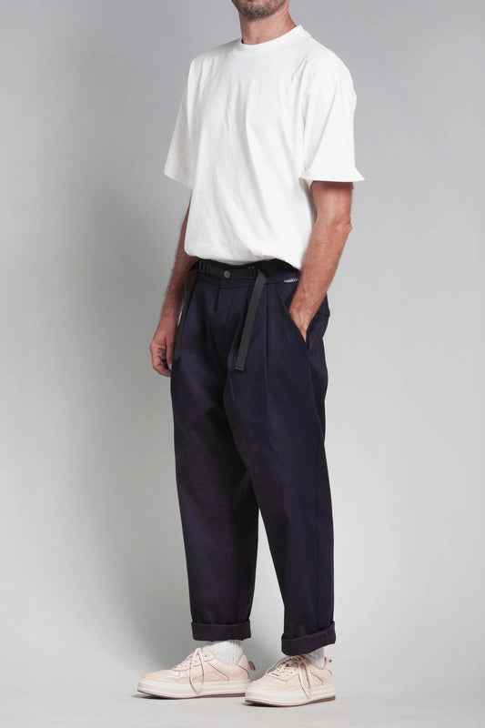 View of a model wearing navy jacquard Patton pants and a white t-shirt