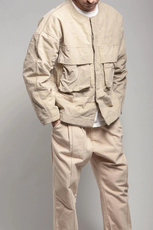 Man wearing a beige Moto Army Jacket and pants against a light background