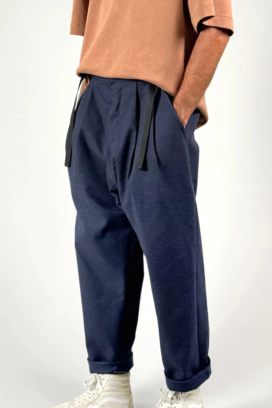 Model wearing dark blue jacquard loose-fit pants and a terracotta t-shirt