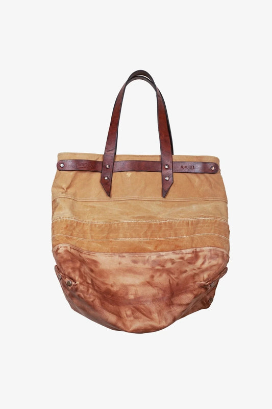 Front view of a rugged, two-tone canvas and leather tote bag