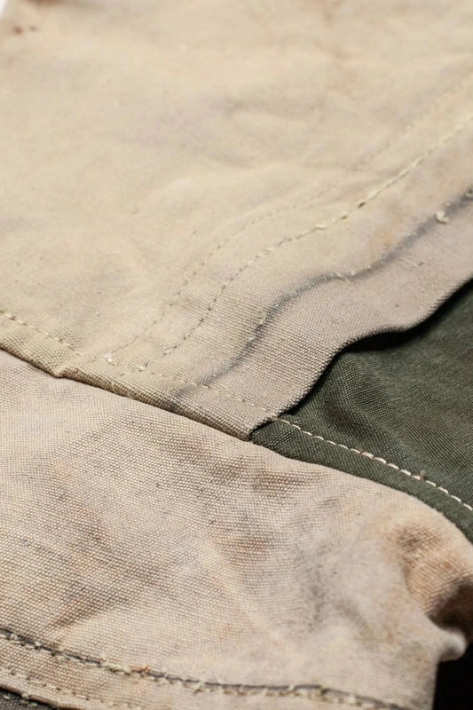 Close-up of a kimono's fabric in beige and dark green with stitching