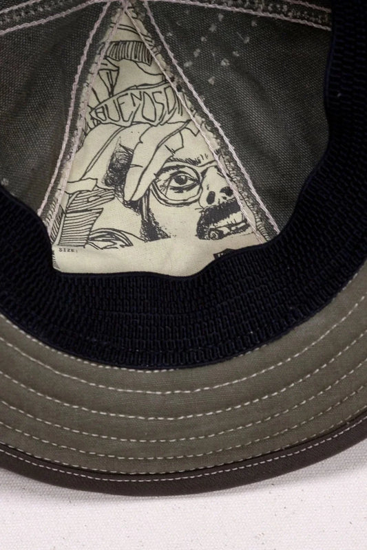 Close-up internal view of a military green temple hat
