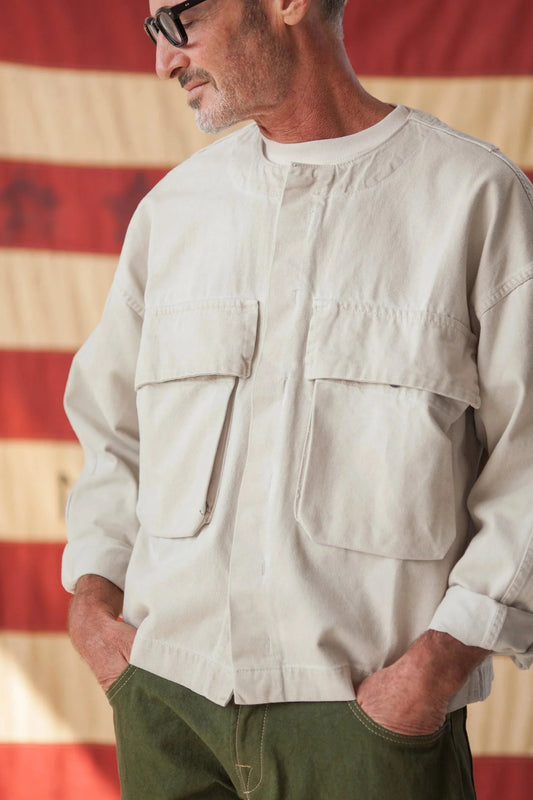 Man wearing a bone overlay jacket and green pants