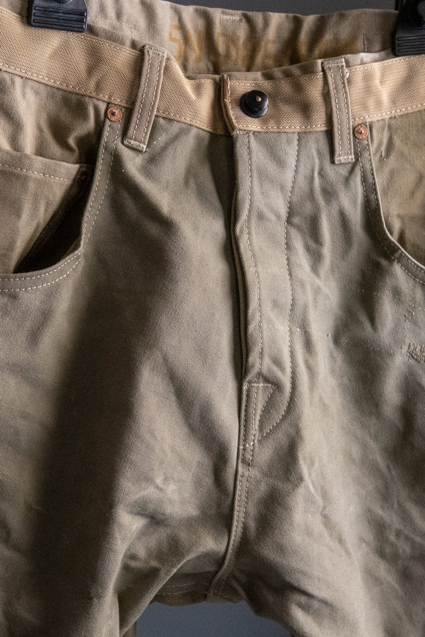Front view of olive green army carrot pants with pockets and details