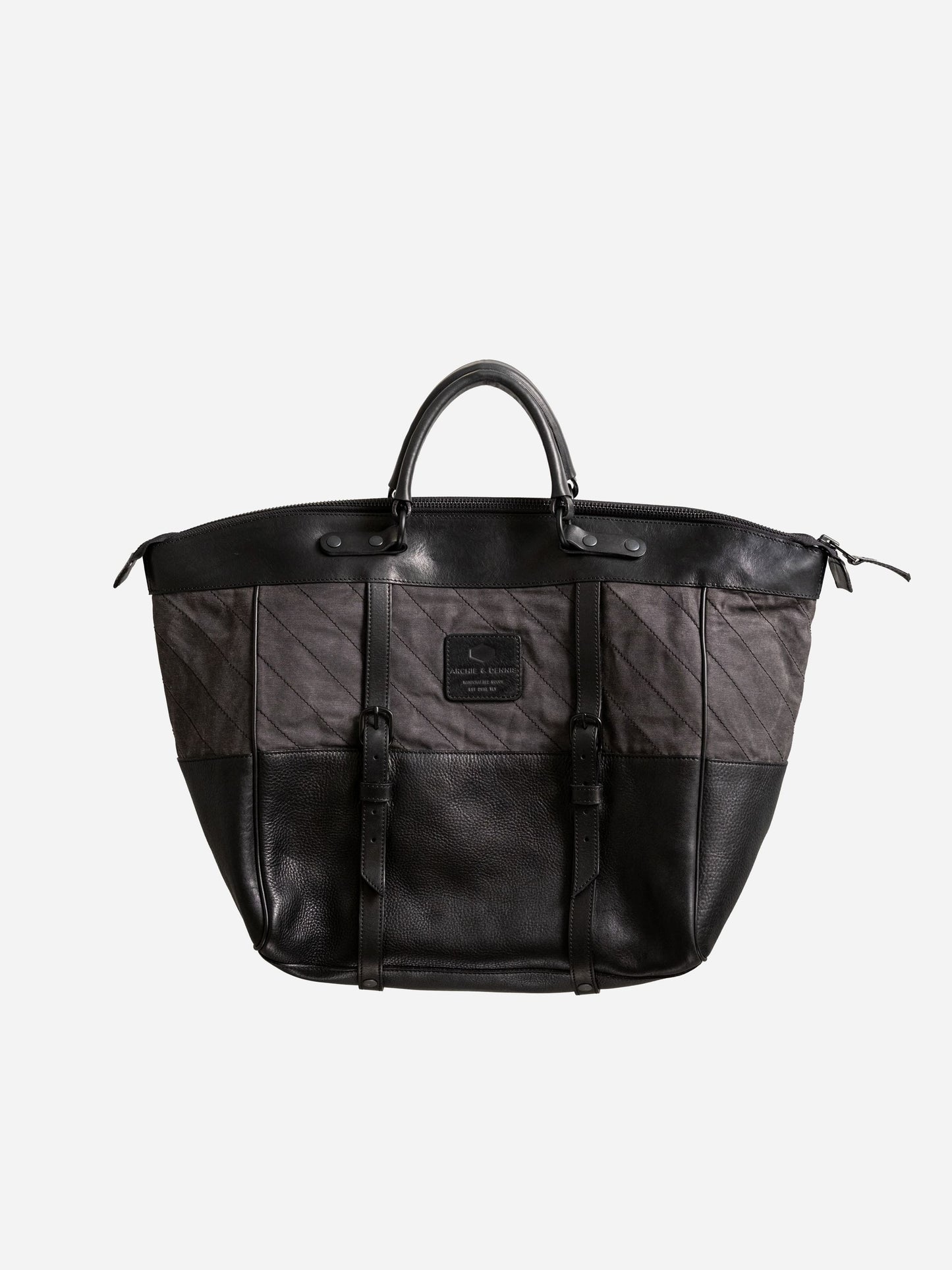 Black and dark gray handcrafted weekend bag with leather accents, dual buckle straps, and a sturdy handle, featuring a minimalist design ideal for utility-inspired menswear.