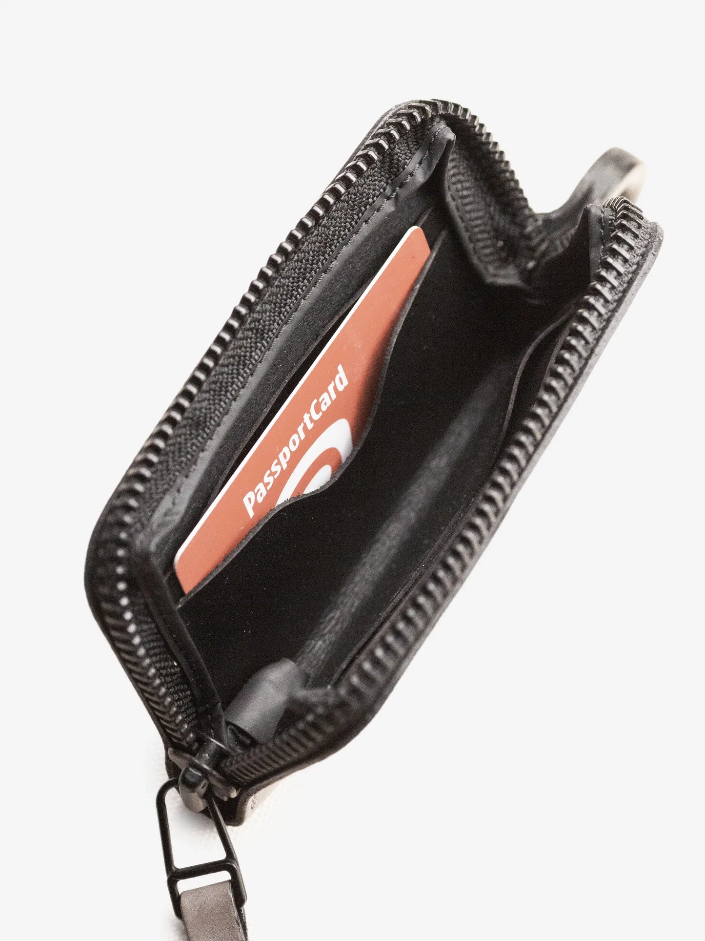 Close-up view of a gray compact wallet with a zipper, featuring an inner pocket holding a red passport card, showcasing a minimalist and functional design.