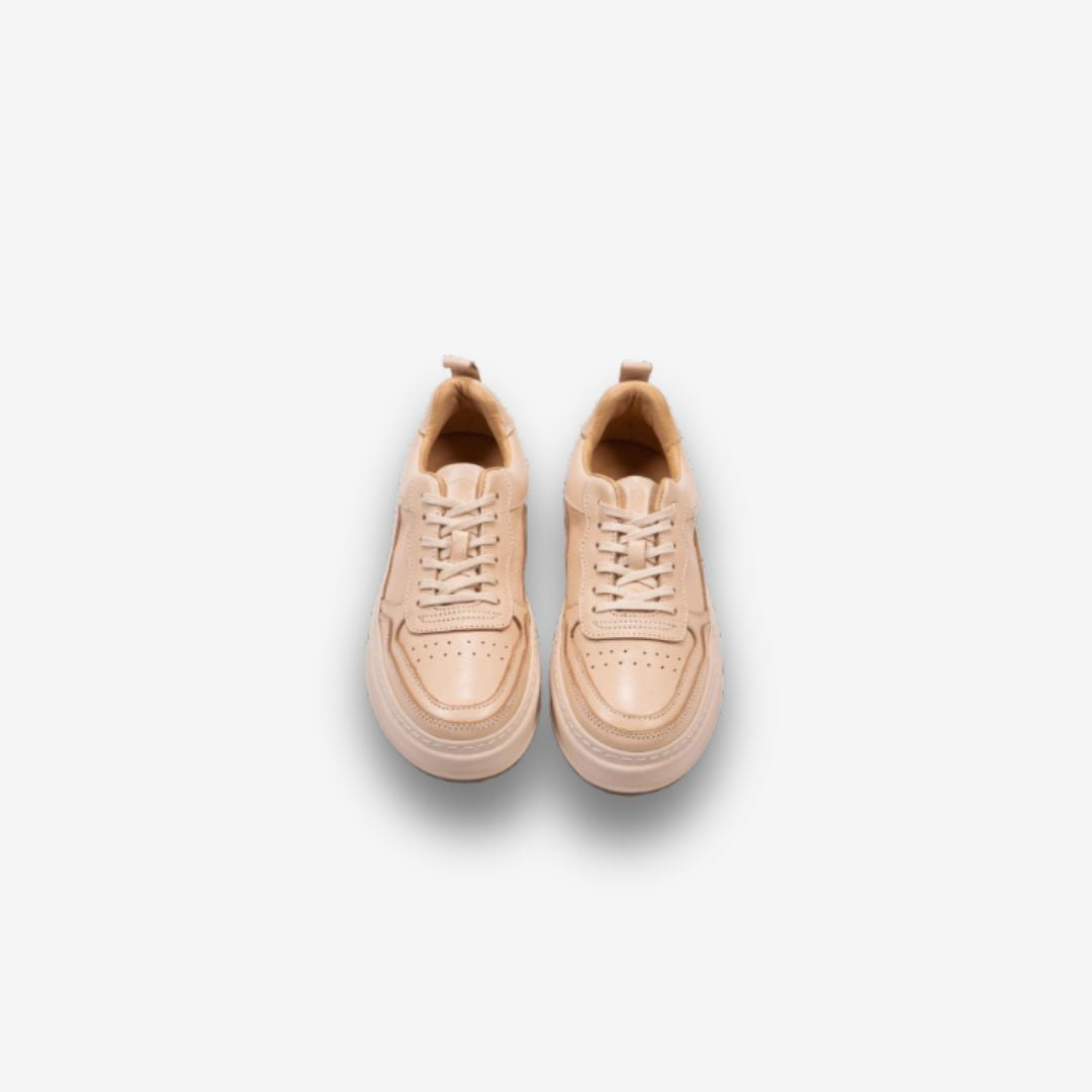 Pair of beige casual sneakers with laces, visible stitching, and perforated details on the toe area, displayed on a white background from a top-down view.