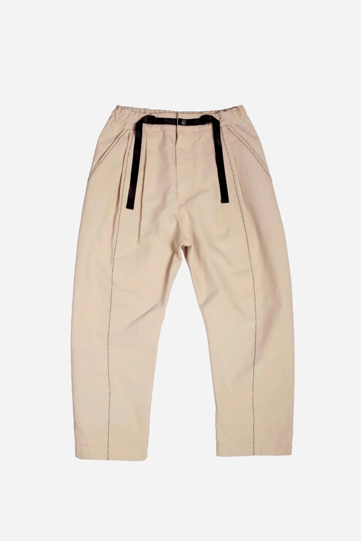 Full front view of beige pants with black straps and stitching