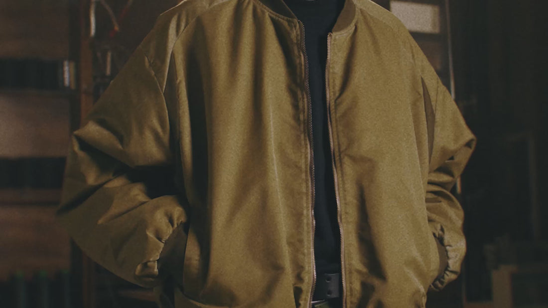 Archie & Dennis menswear video cover showing rugged utility trousers and oversized knit styling.

