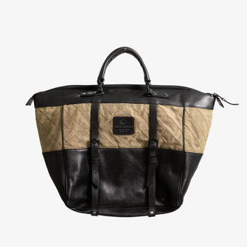 Two-tone olive and black handmade tote bag with leather straps and quilted fabric detailing, designed as a stylish, utility-inspired weekend bag.