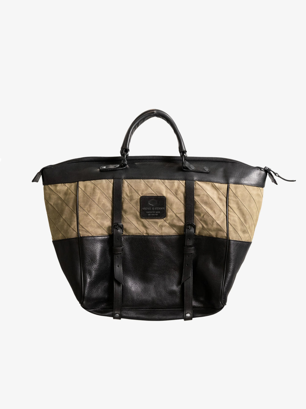 Two-tone olive and black handmade tote bag with leather straps and quilted fabric detailing, designed as a stylish, utility-inspired weekend bag.