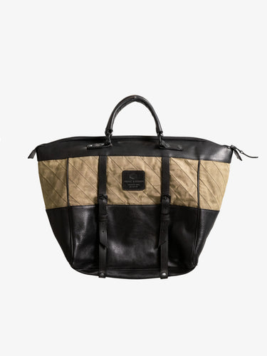 Two-tone olive and black handmade tote bag with leather straps and quilted fabric detailing, designed as a stylish, utility-inspired weekend bag.